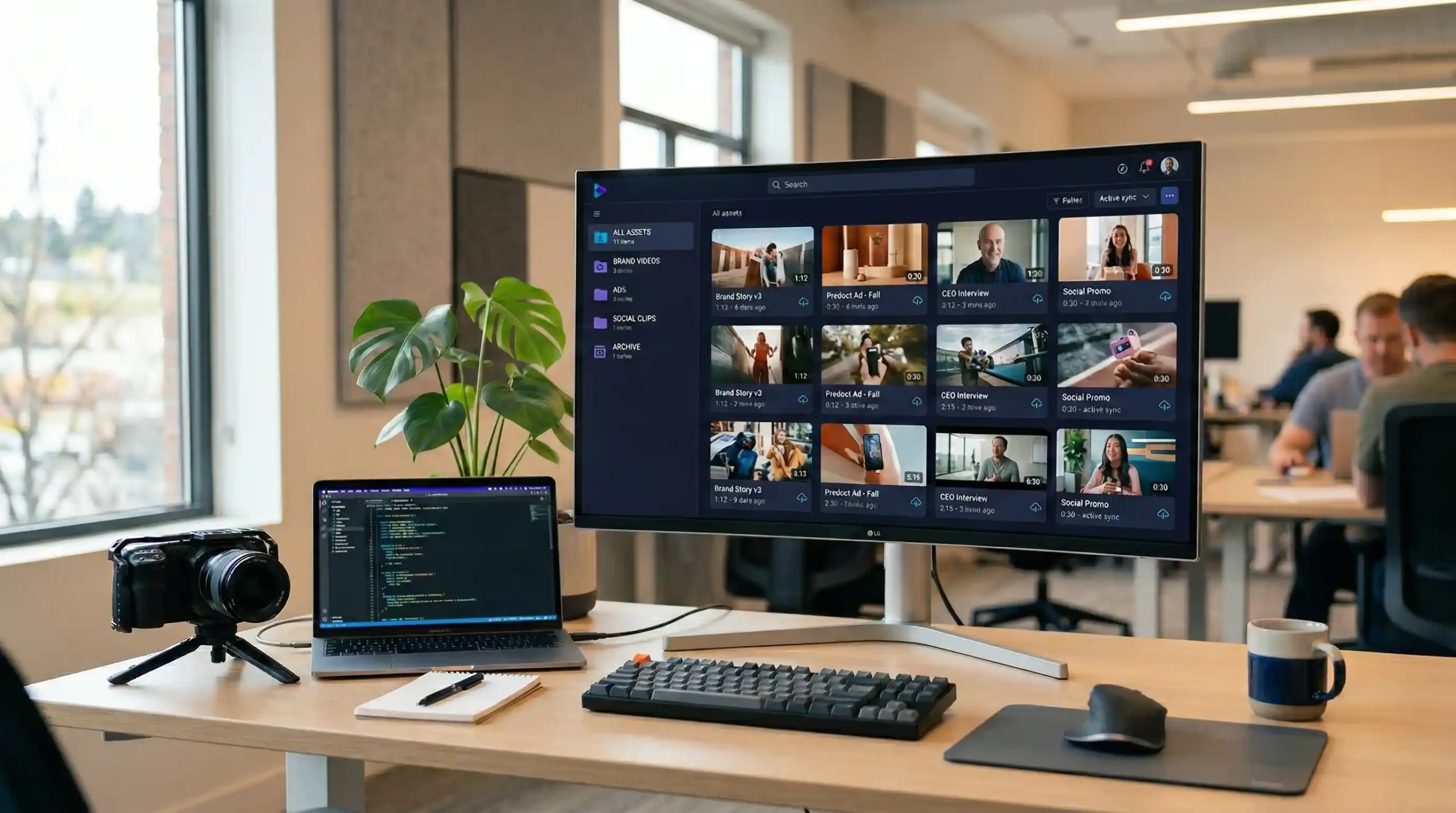 Modern startup workspace displaying a video asset library dashboard with organized video folders and cloud storage system.